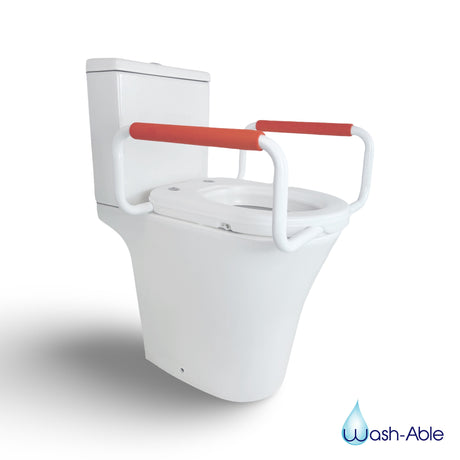 A raised toilet seat with support rails fitted to a standard toilet - no clinical setting, feels like a home.