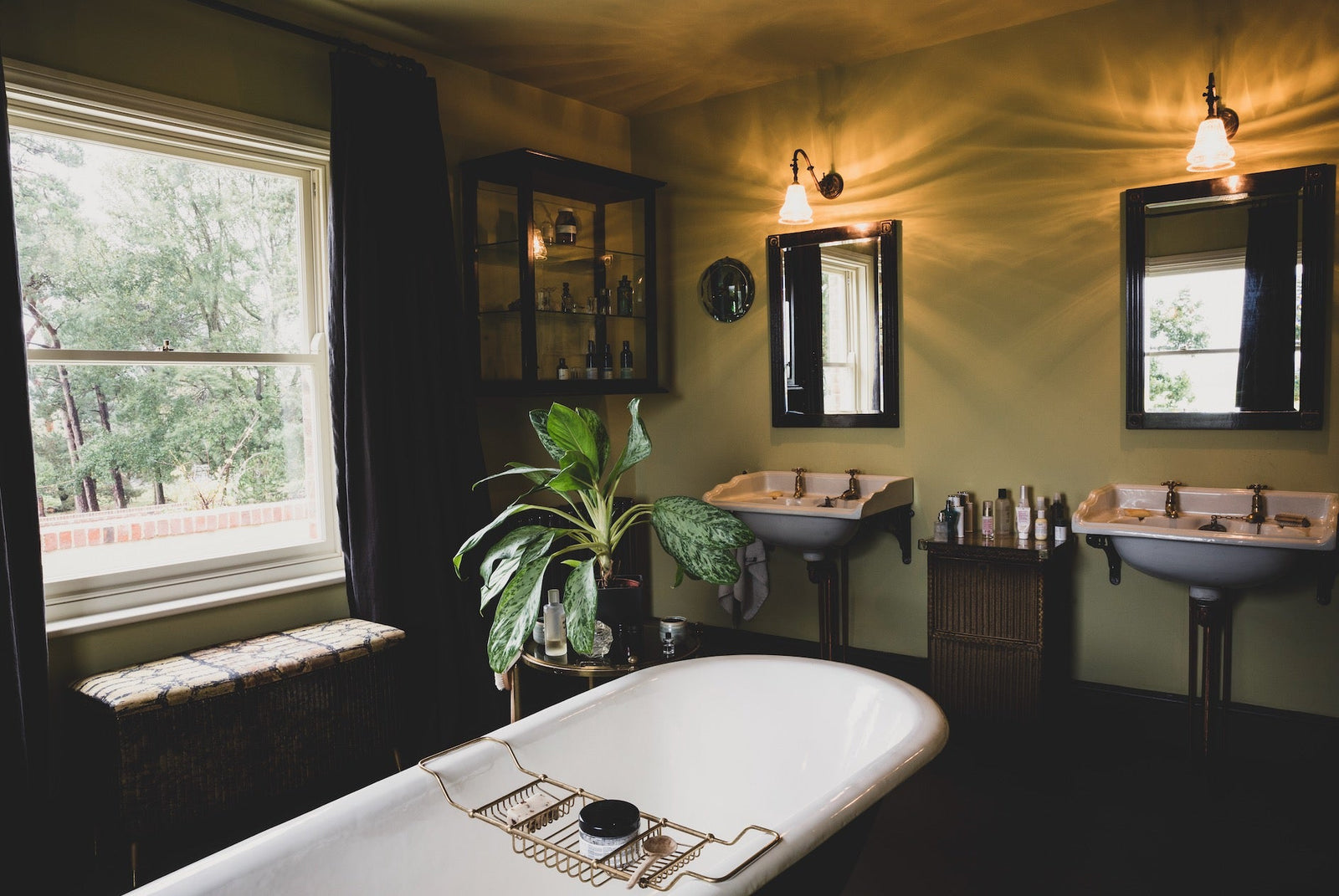 A beautifully restored period bathroom featuring original wooden floors - where a discreet, modern Wash-Able smart toilet would blend into the historic setting.