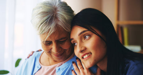 A supportive scene showing an adult child and an elderly parent comfortably discussing home plans.